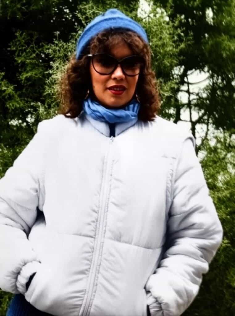 Woman in white winter coat outdoors.