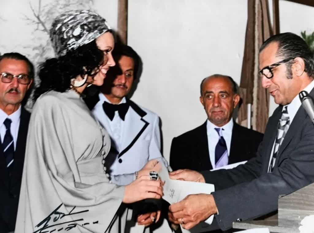 Award ceremony with people exchanging certificates and handshakes in a formal setting.
